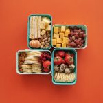 Red and Brown Fruits on Green Plastic Containers