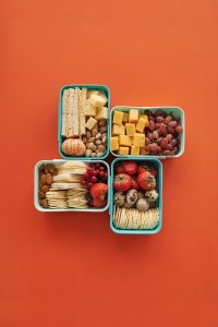 Red and Brown Fruits on Green Plastic Containers