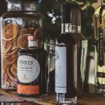 selective focus photo of two black and white labeled bottles